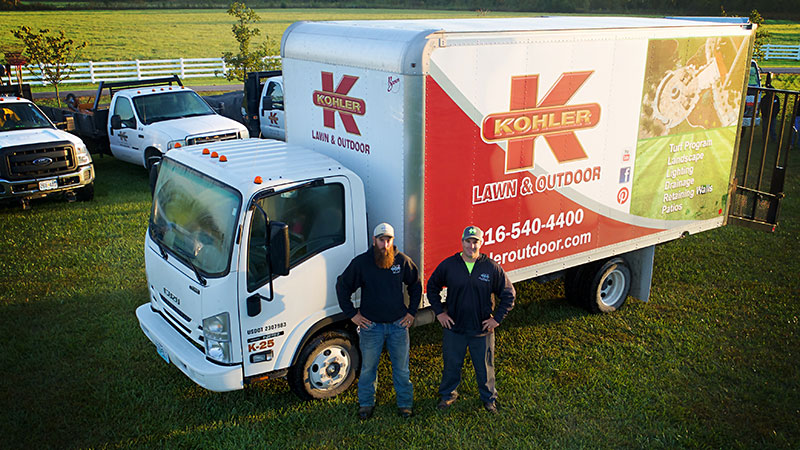 Turf Treatment. Image of Kohler Lawn & Outdoor truck with 2 employees.